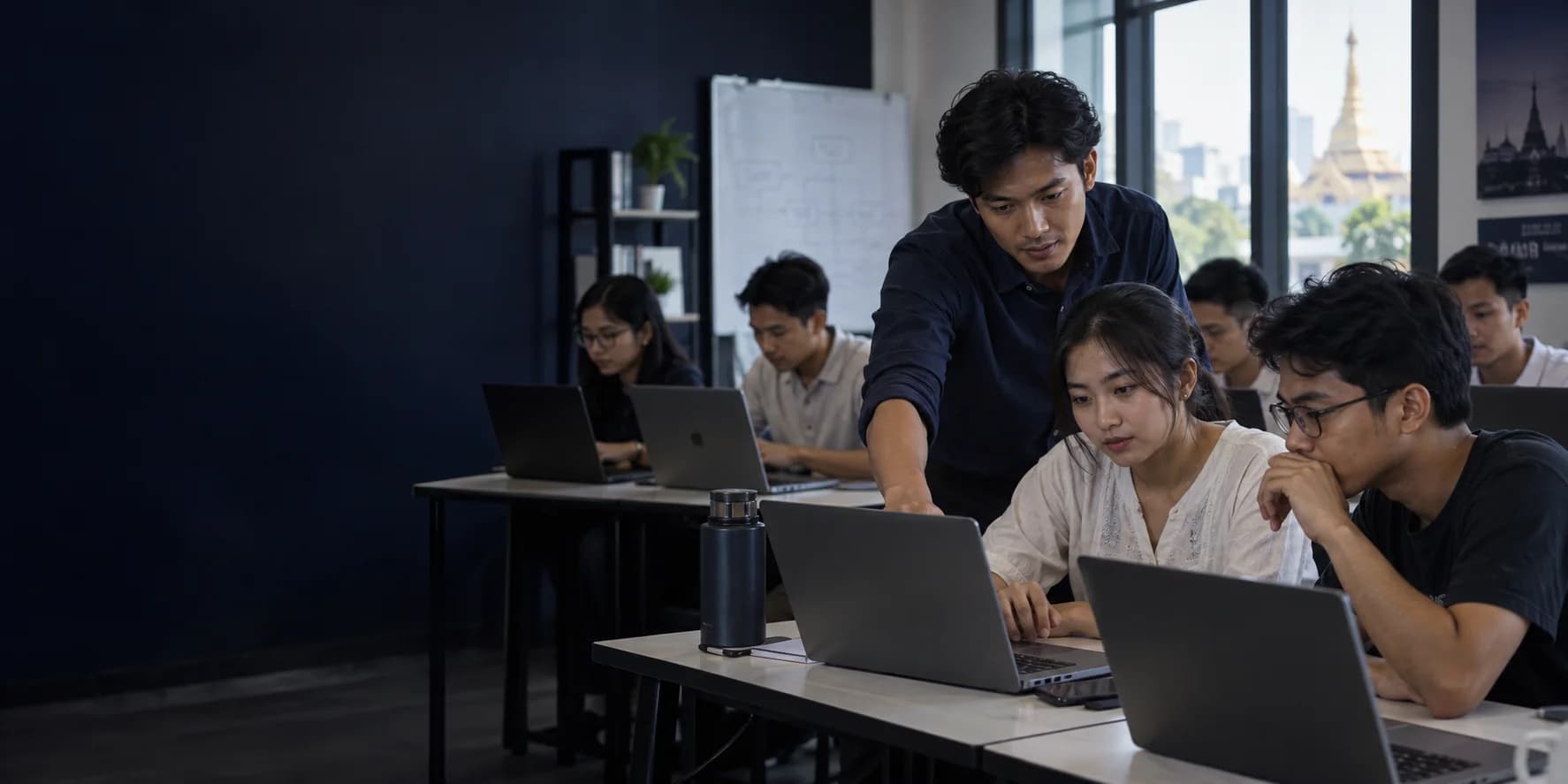 An instructor guiding technology learners in a practical classroom